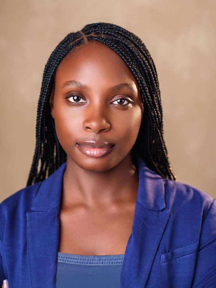 Portrait of a young woman with long braids in a blue blazer