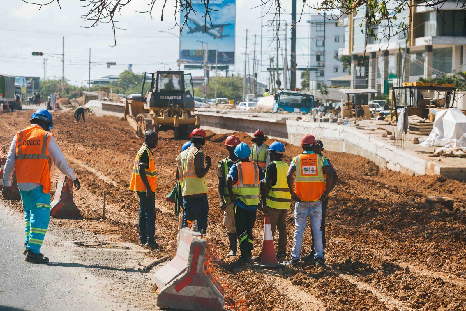 Road construction crew in safety gear at a roadworks site