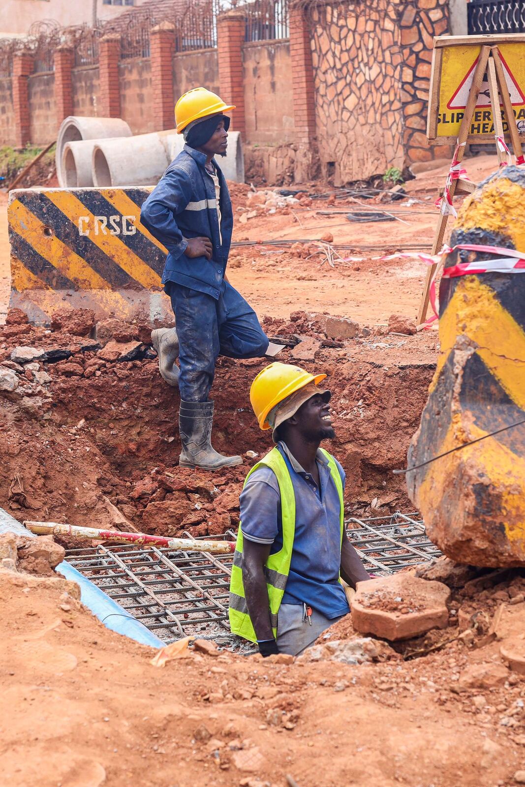 Construction workers excavating at a site in Kampala